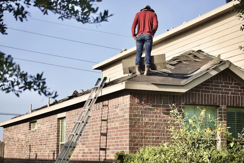 Professional roofer working on a residential roof in Waldoboro